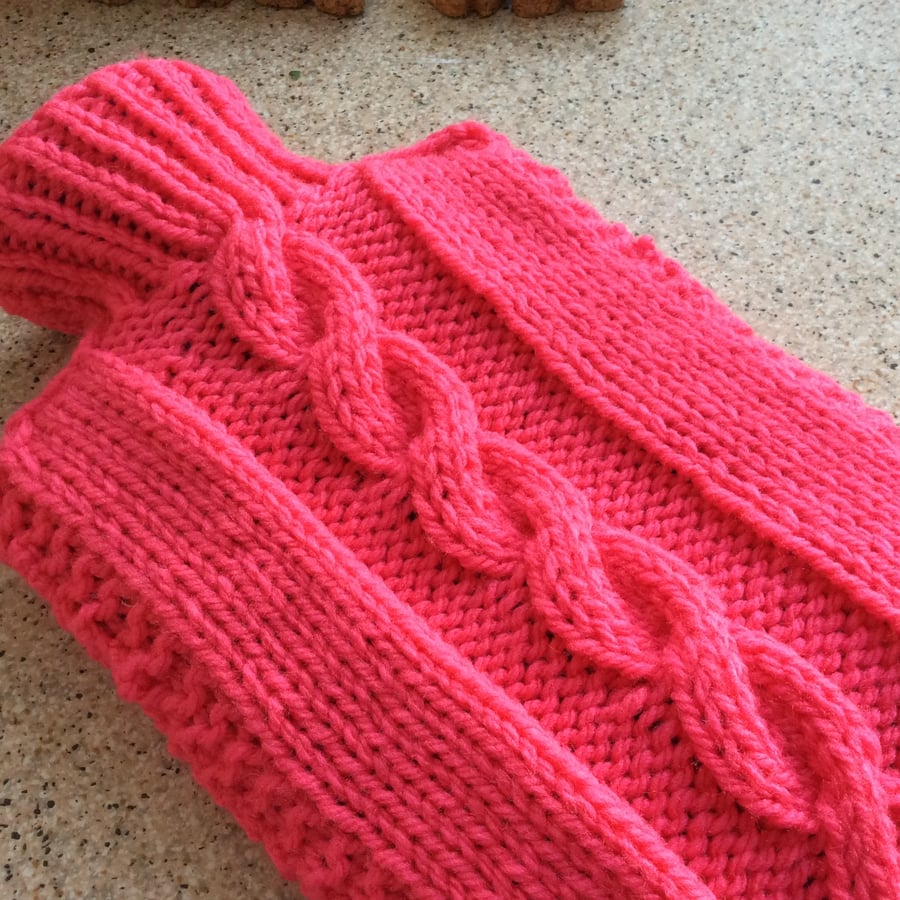 Knitted Hot Water Bottle Cover in bright pink, warm toes all year