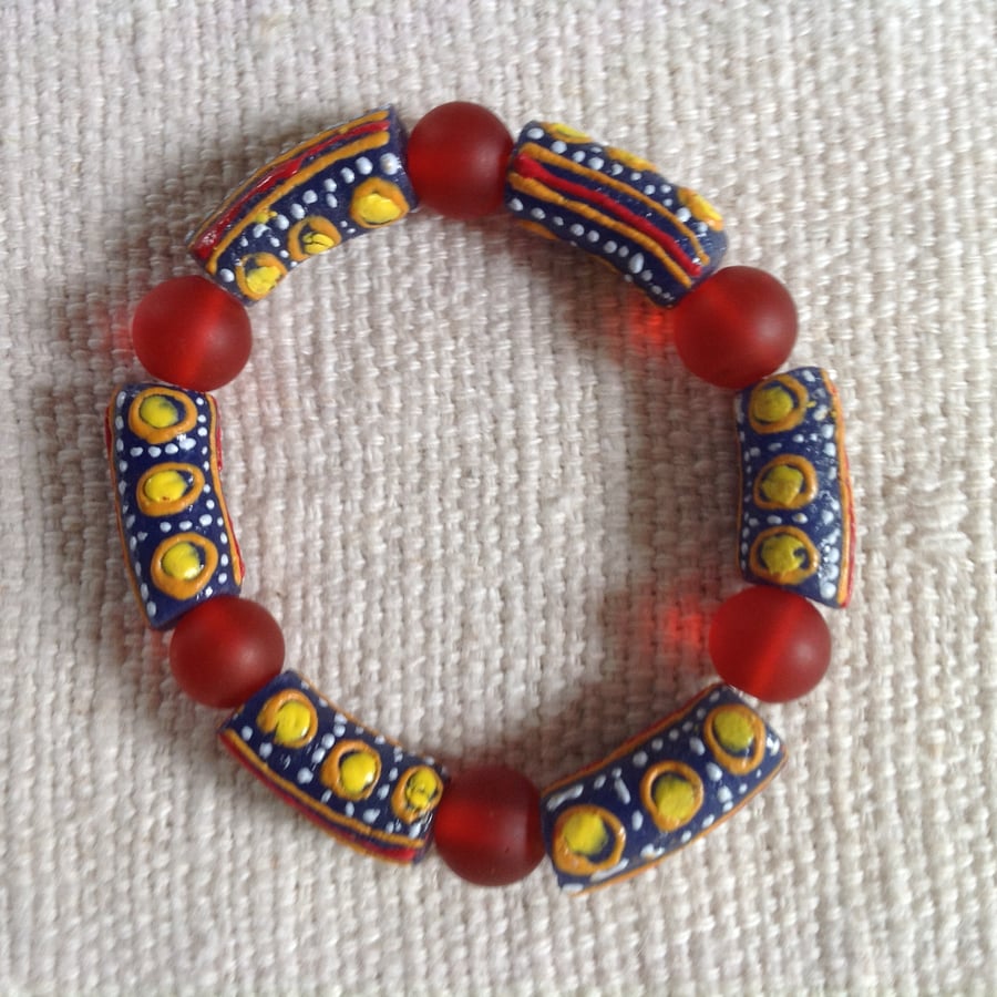 6.5" African bead bracelet with red, blue, yellow and white beads 