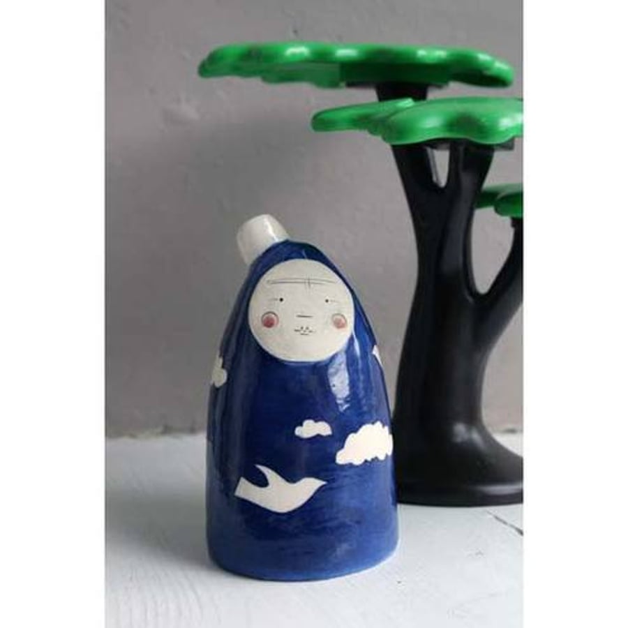 Moon face bottle sculpture - blue skies, white clouds, white dove