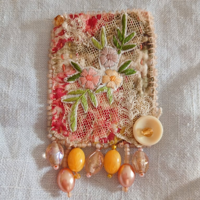 Peach and yellow floral brooch.
