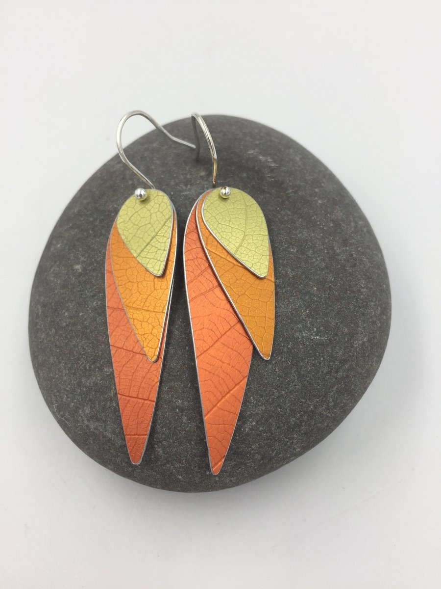 Anodised aluminium 3 layer parrot wing earrings in orange and yellow.