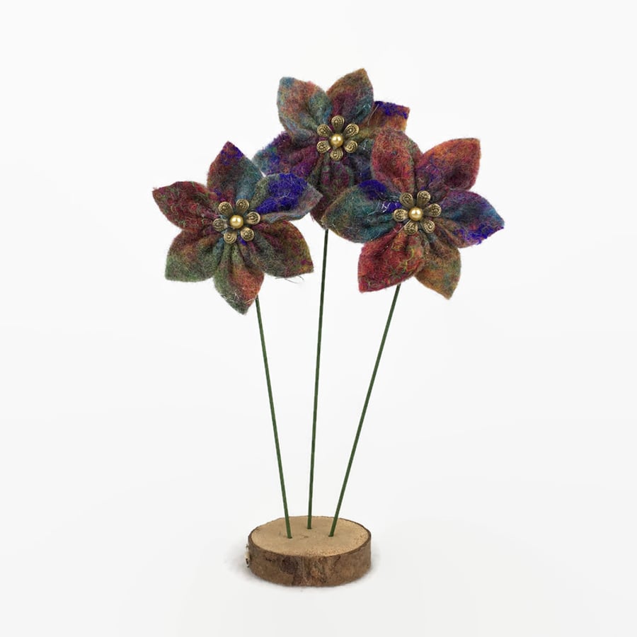 Felted flower decoration on wooden base