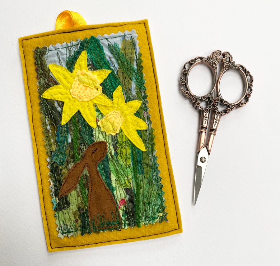 Upcycled embroidered spring rabbit and daffodil home decoration. 