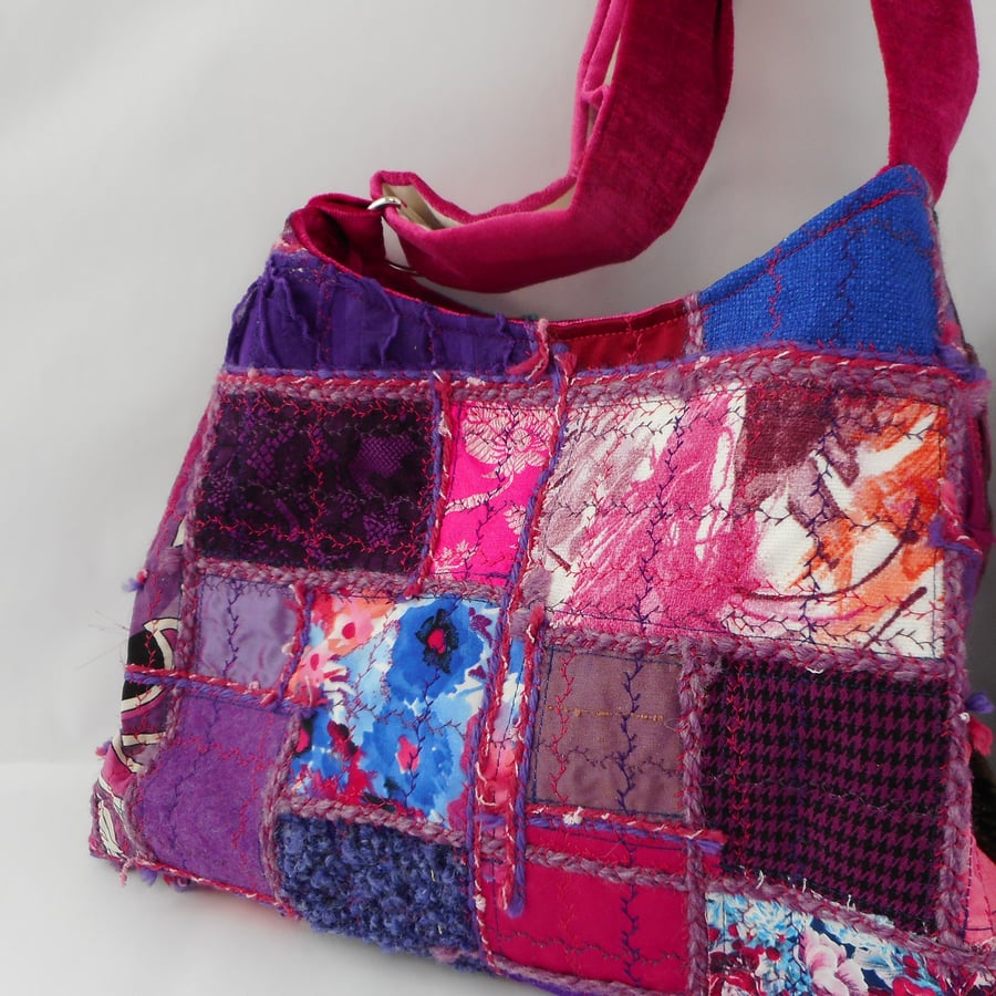Luxury velvet and mixed textiles cross body bag in purple and pink