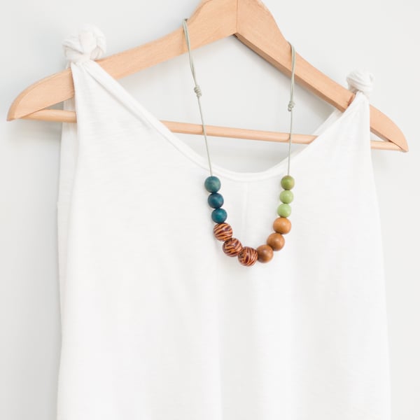 Tigi - Wooden bead necklace, green, blue and golden brown with zebra beads 