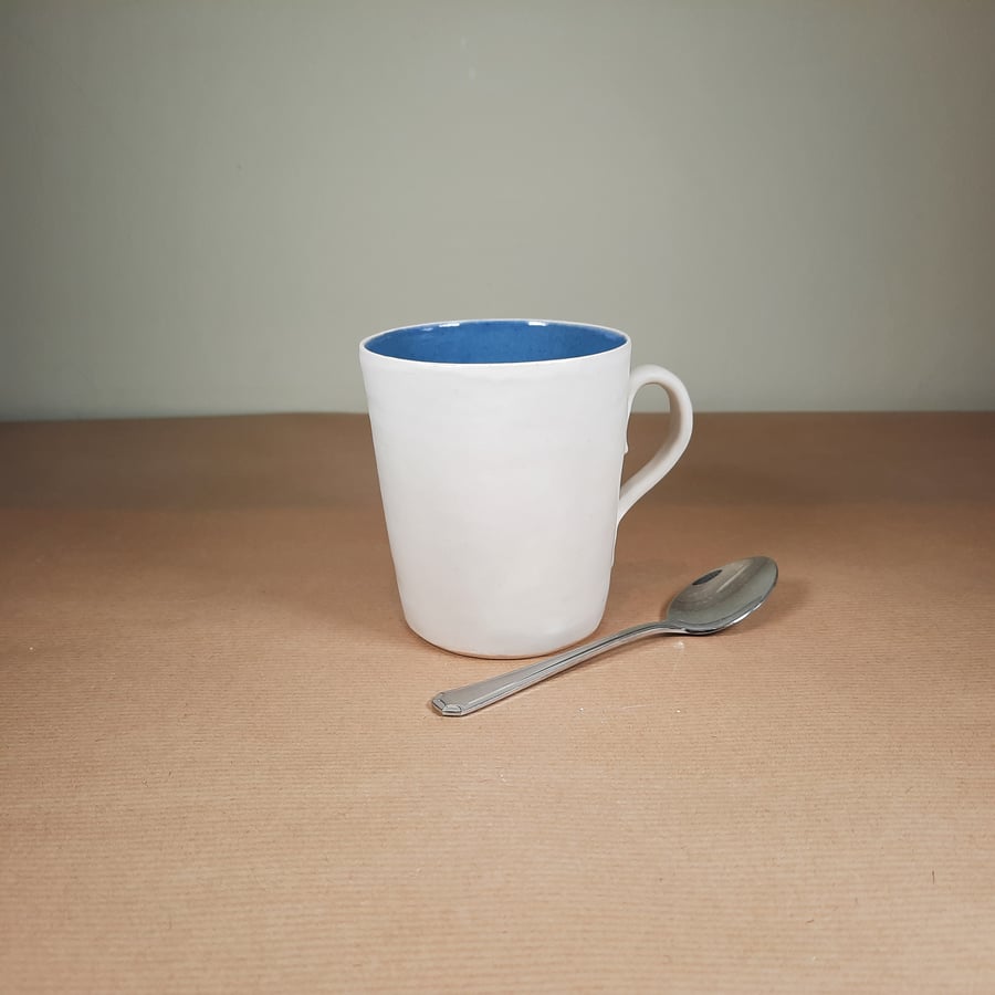 Hand thrown tall blue and white ceramic mug
