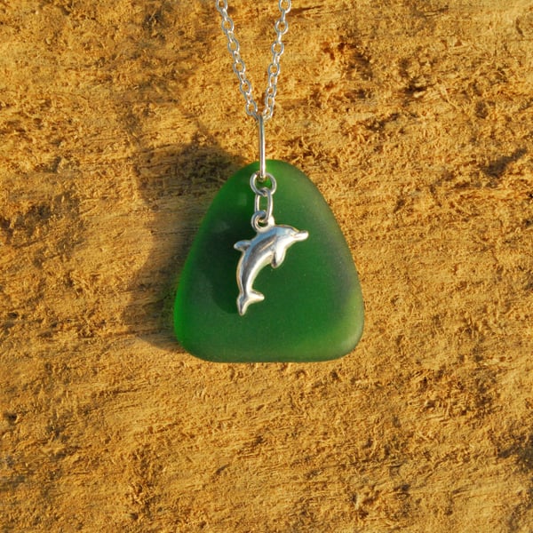 Green beach glass pendant with dolphin charm