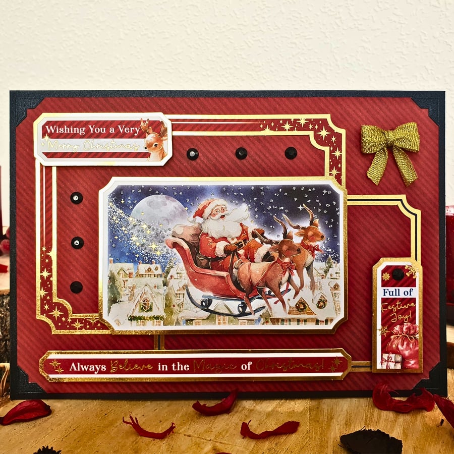 Christmas Card With Father Christmas On His Reindeer Sleigh in Red & Black