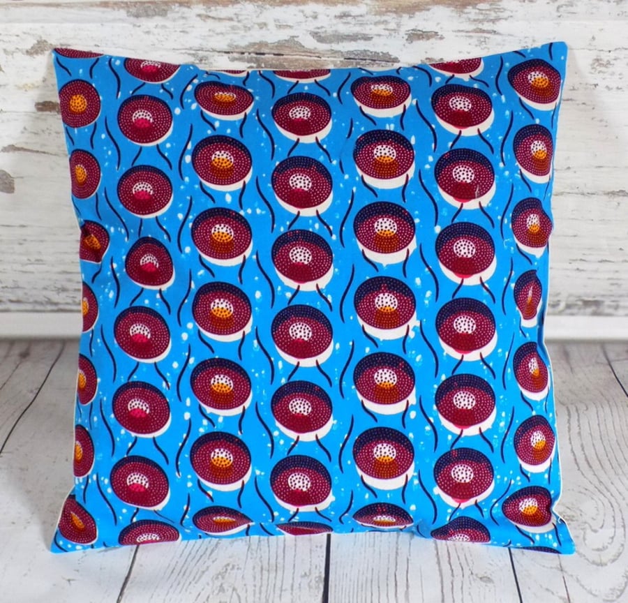 Cushion cover. African wax print, multicolour circles on bright blue