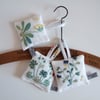 A Set of 3 lavender bags with vintage botanical embroidery.