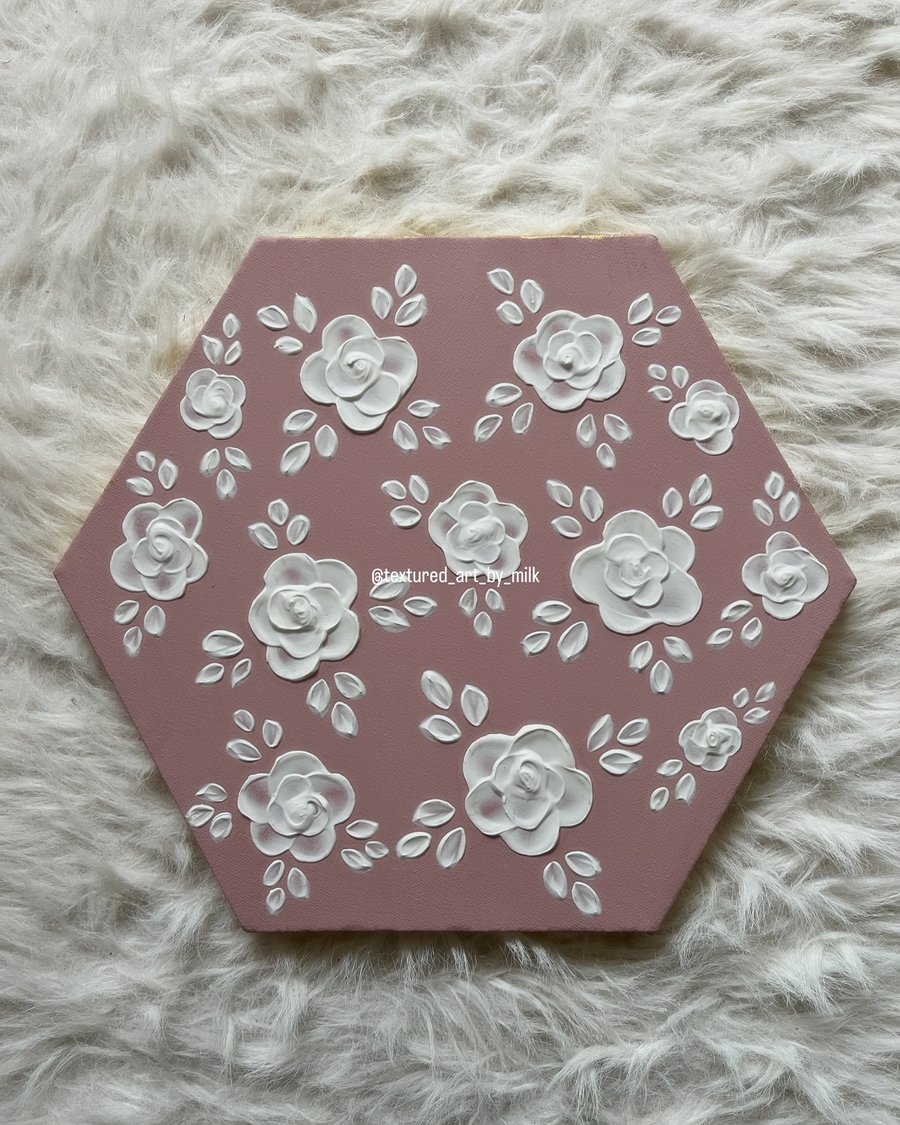 White textured roses with a dusky pink background 