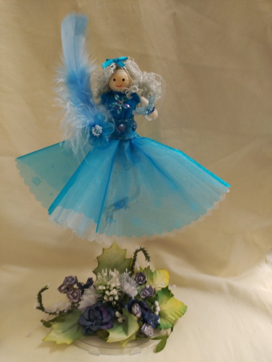 Bespoke Handmade Fairy Doll with a light blue dress on a floral base  stand