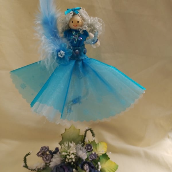 Bespoke Handmade Fairy Doll with a light blue dress on a floral base  stand