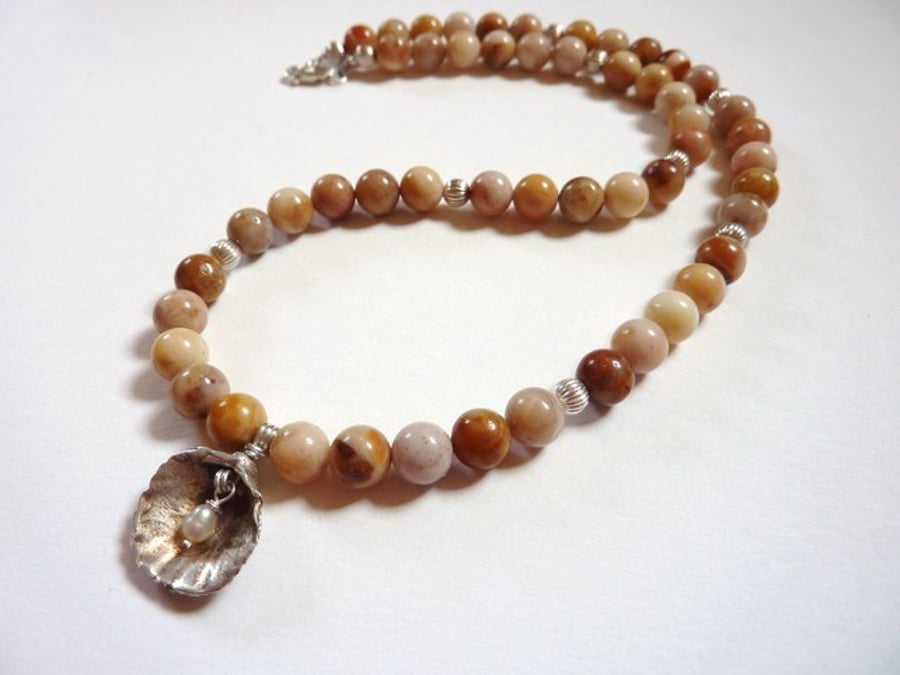 Shell with pearl necklace