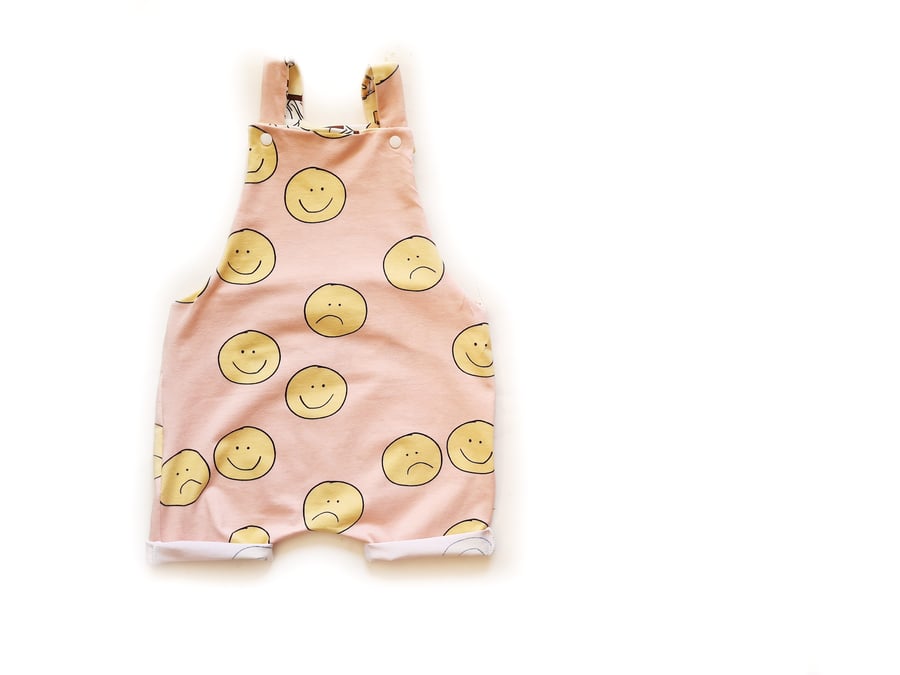Short dungarees in a pink Smiley print, sizes 0-3 up to 5-6