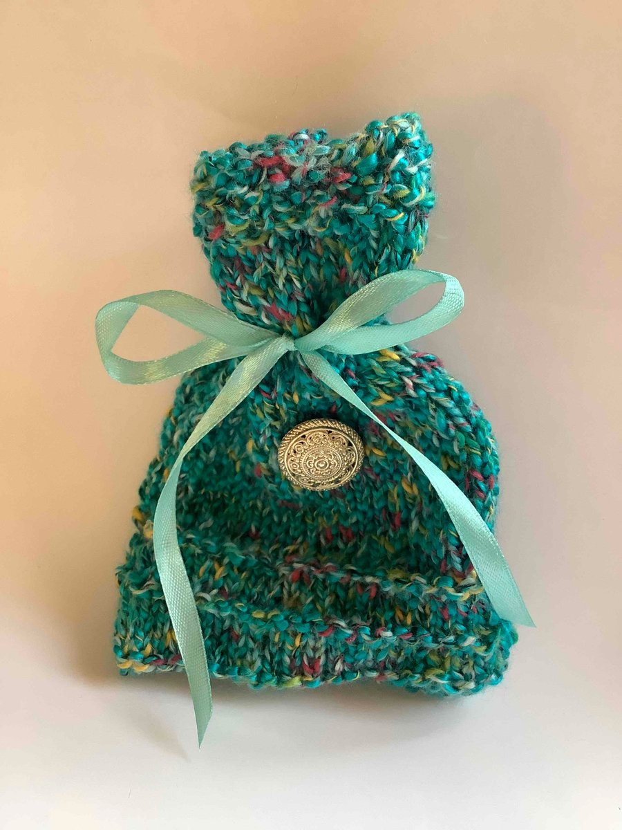   Turquoise knitted gift bag with silver button