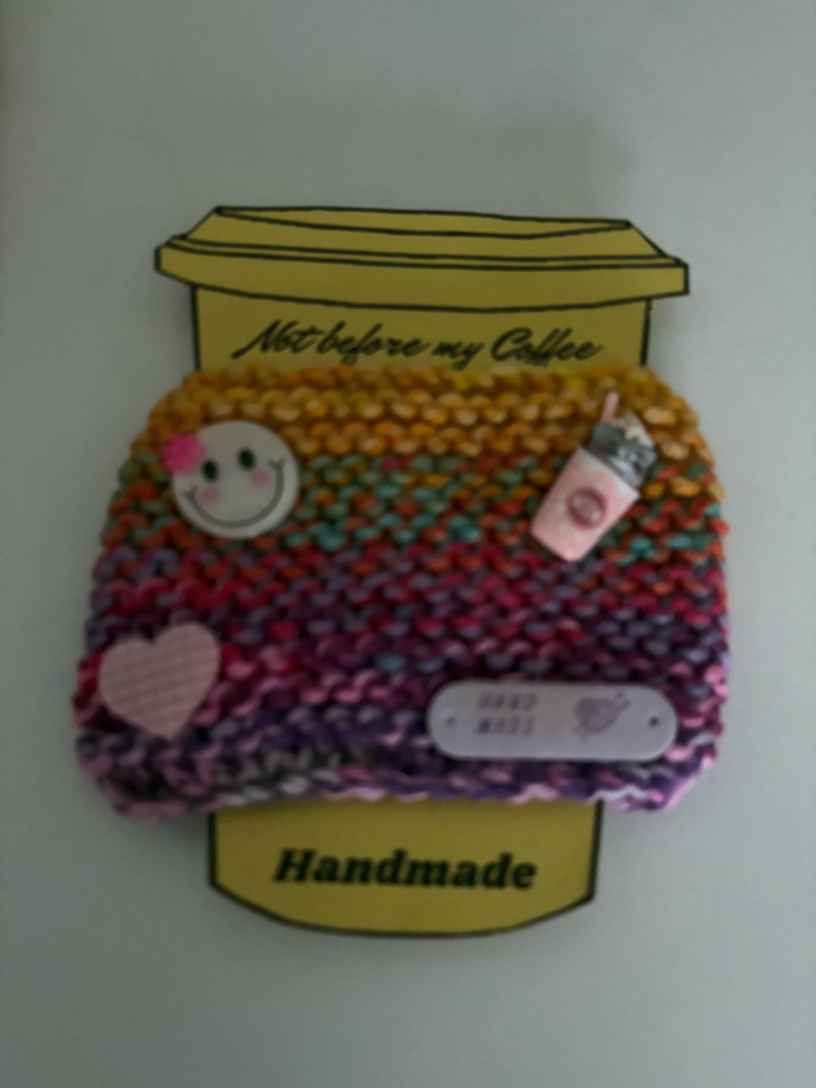 Smiley knitted cup cosy. 