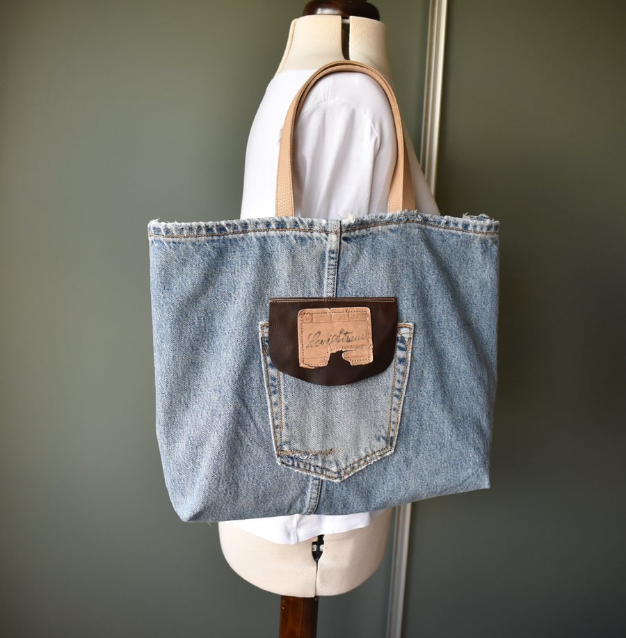Distressed and recycled denim tote bag. Good size for shopping or work.