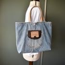Distressed and recycled denim tote bag. Good size for shopping or work.