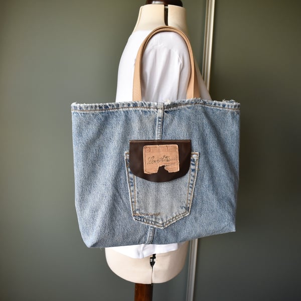 Distressed and recycled denim tote bag. Good size for shopping or work.