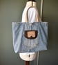 Distressed and recycled denim tote bag. Good size for shopping or work.