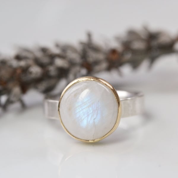 Moonstone and sterling silver ring with gold bezel setting. 