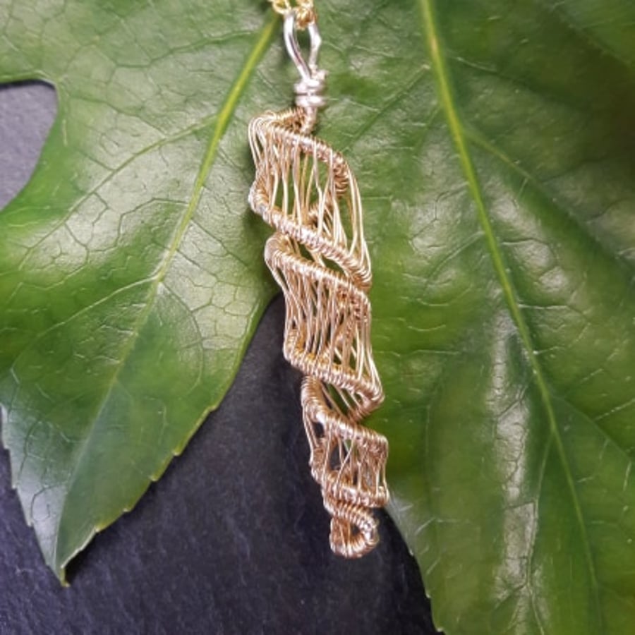Wire wrapped shell shaped pendant