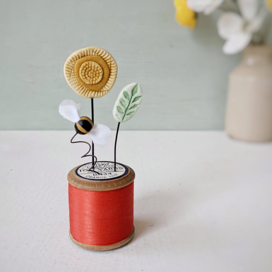 Clay Flowers and Bee on a Vintage Bobbin