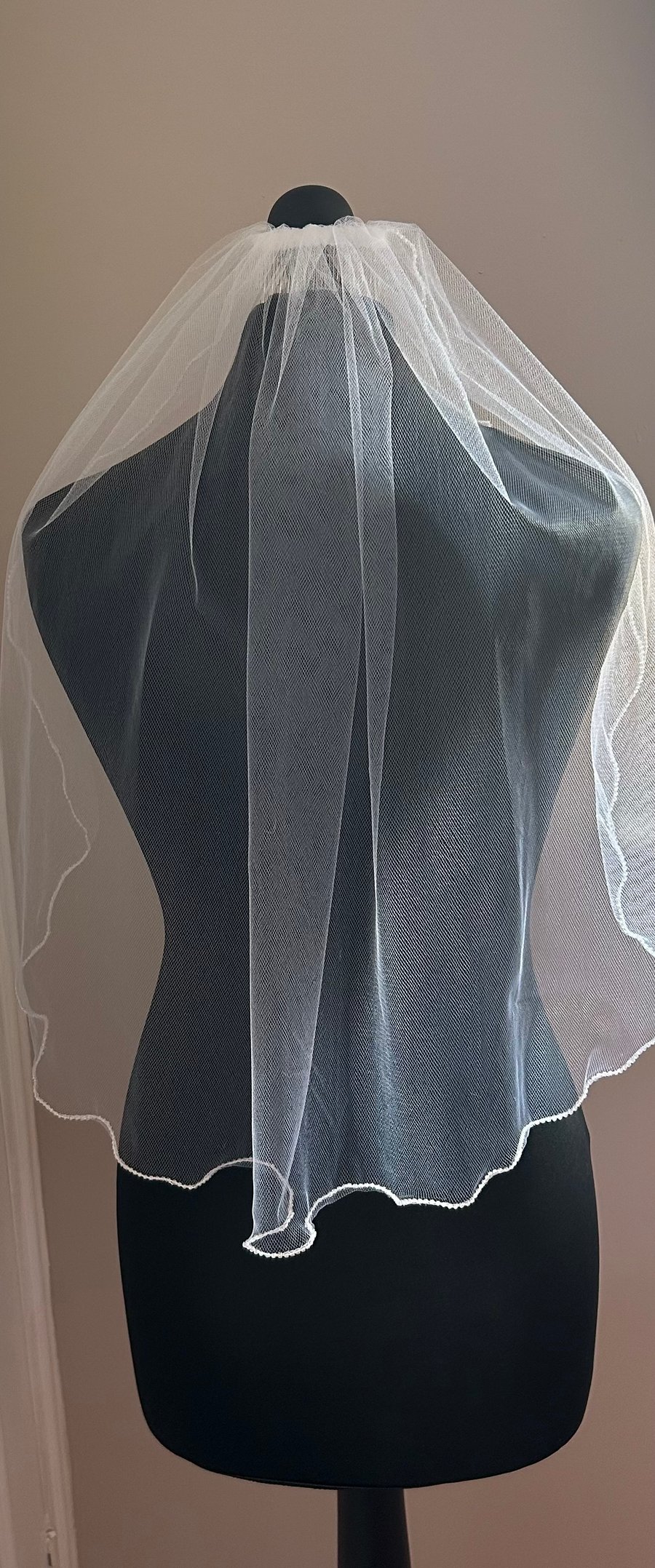 White elbow length veil with pearlescent beading