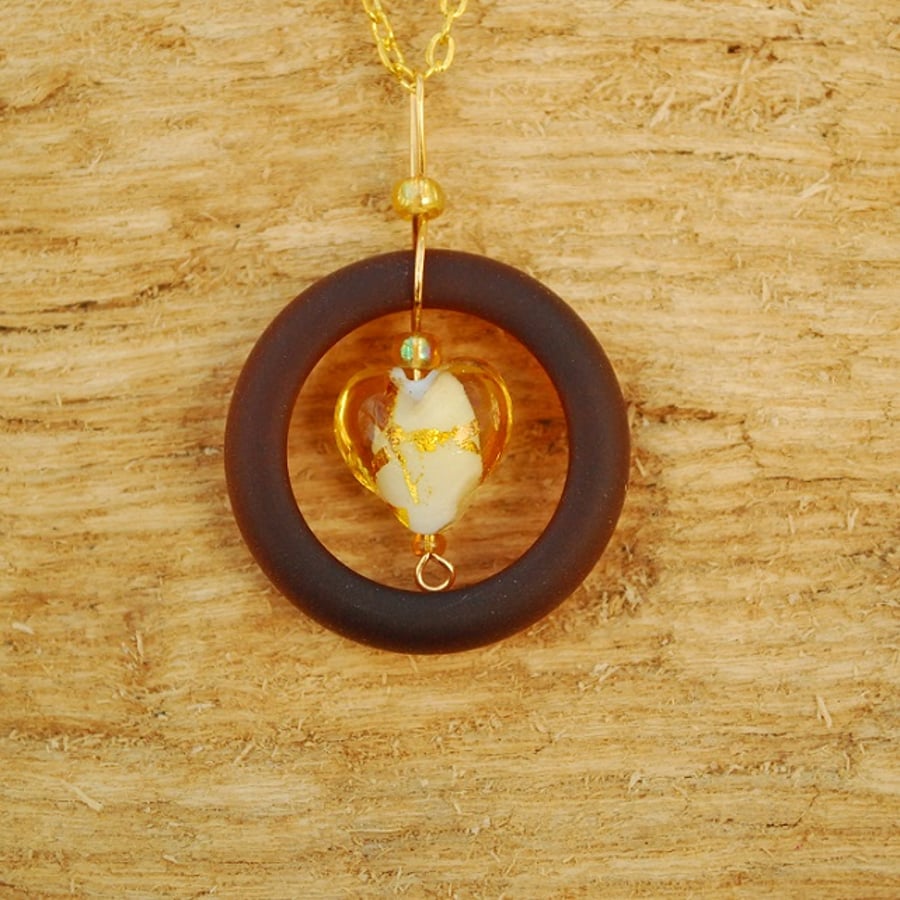 Brown glass pendant with gold heart
