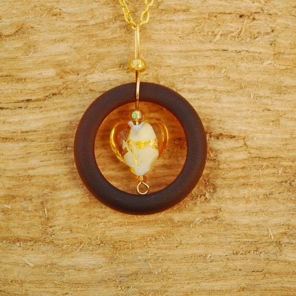 Brown glass pendant with gold heart