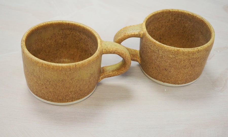 Pottery mug finished natural sand colour glaze. Straight sided.