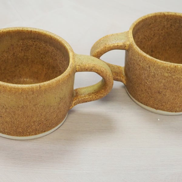 Pottery mug finished natural sand colour glaze. Straight sided.