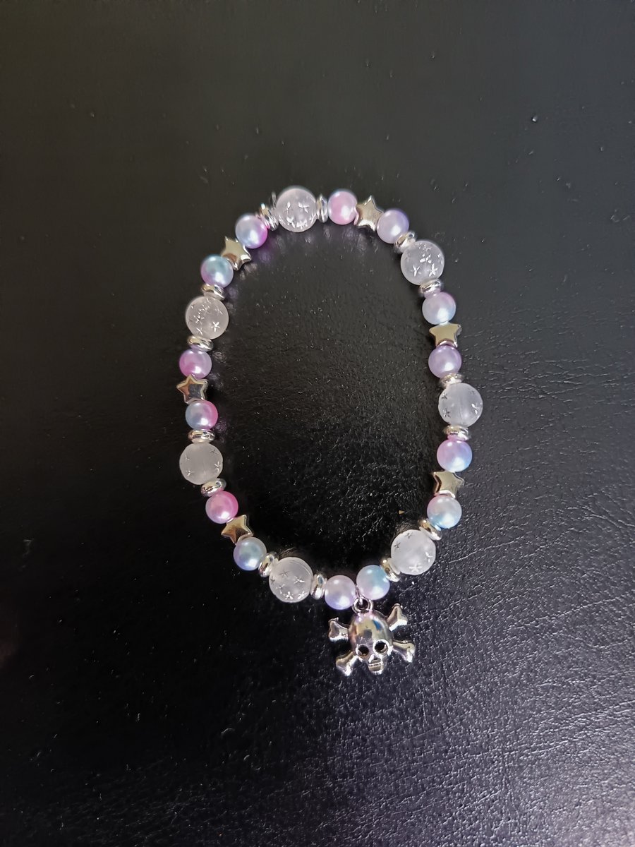 Elasticated skull and crossbones charm bracelet with pastel beads