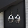 White & black with a touch of glitter enamel scale earrings. Sterling silver. 