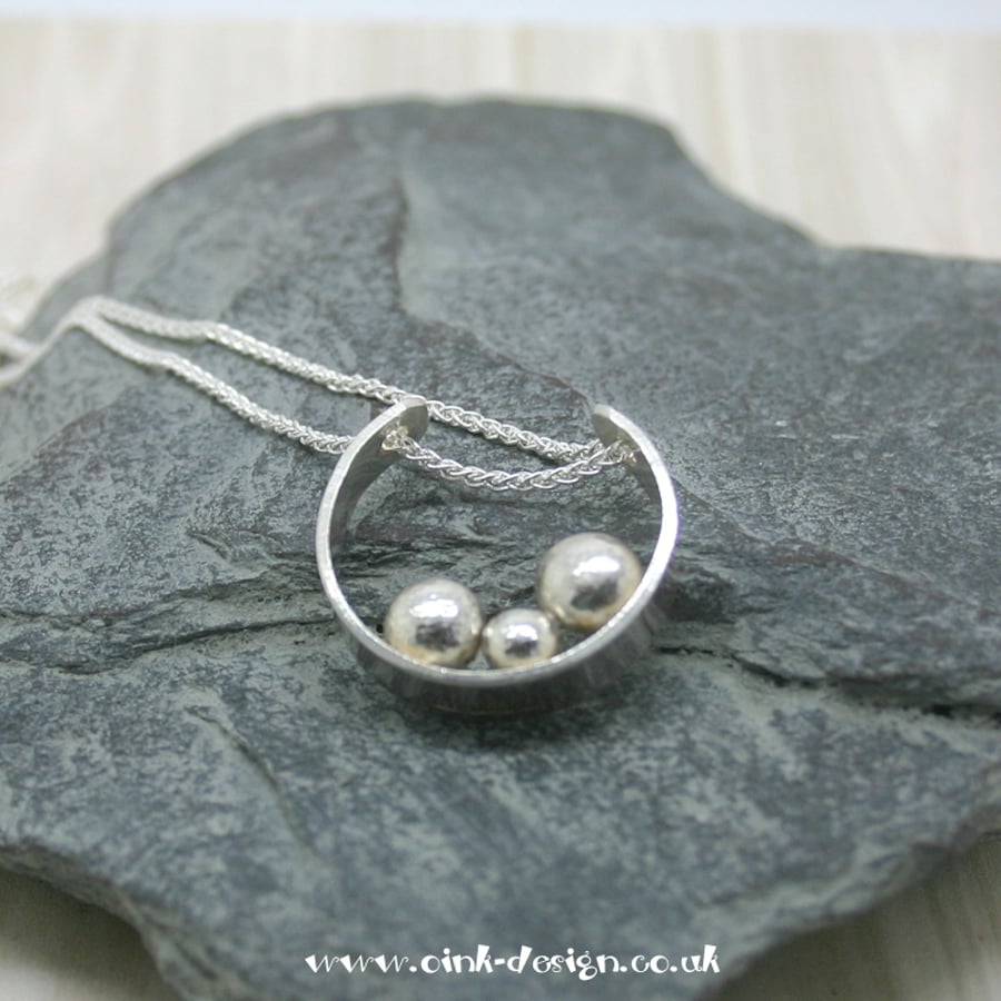 Sterling Silver open circle with 3 sterling silver pebbles