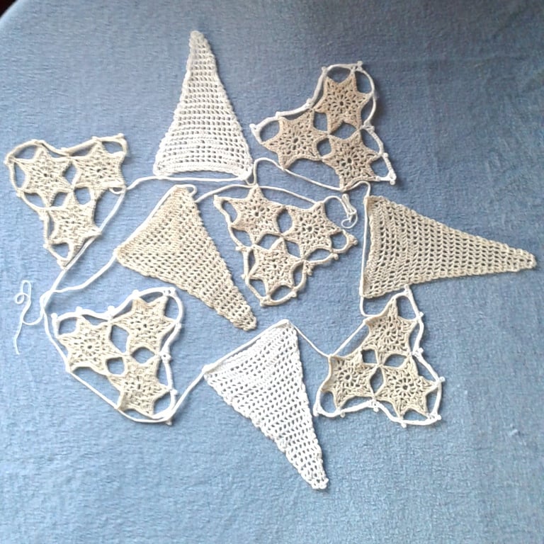 Bunting, hand crocheted lace from a vintage pattern with Filet and stars motifs.