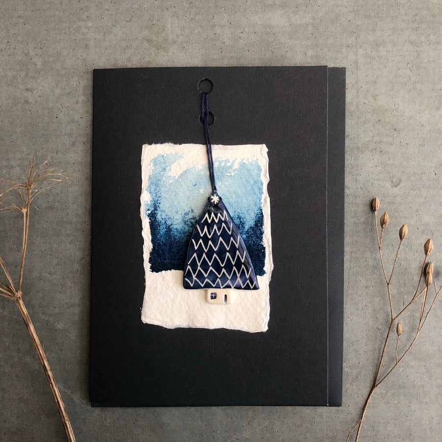 Card with ceramic tree decoration.