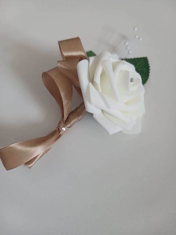 White foam rose buttonholes with gold ribbon details