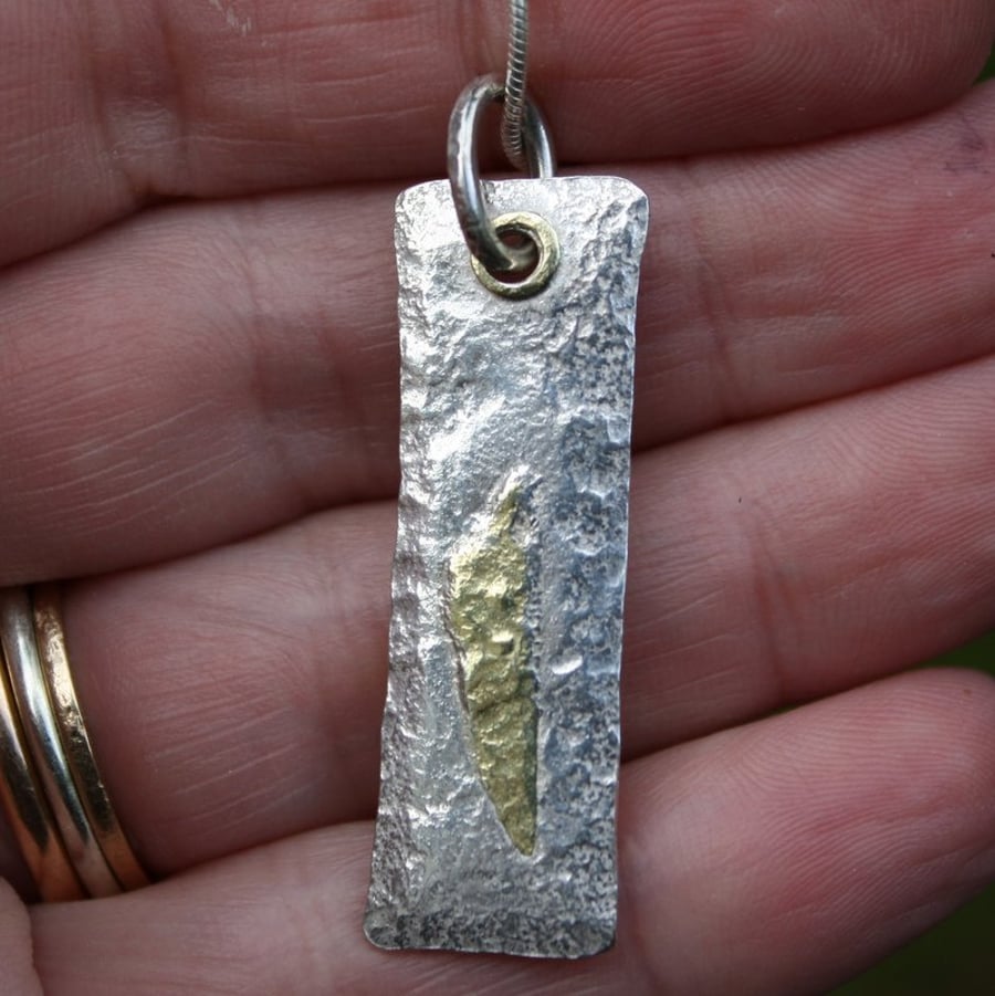 Silver and 18ct gold Tag pendant on chain.
