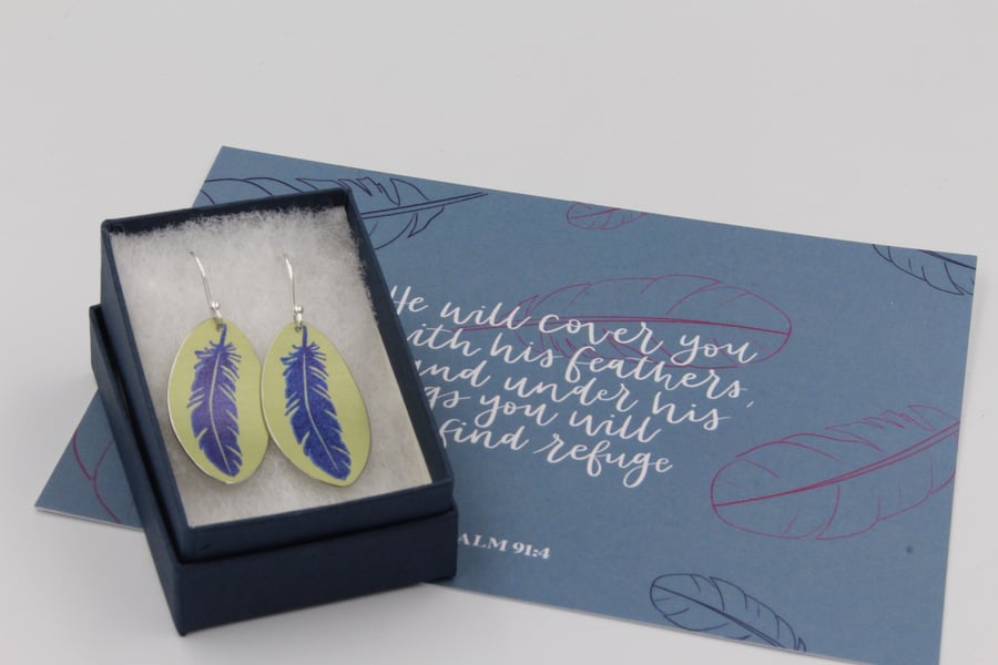 Lime green anodised aluminium oval feather earrings and postcard set.