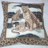 Beautiful Snow Leopard sitting with her two cubs cushion