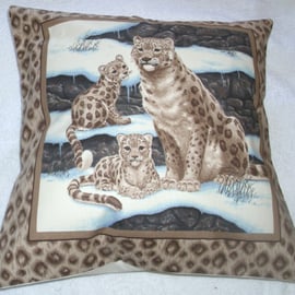 Beautiful Snow Leopard sitting with her two cubs cushion