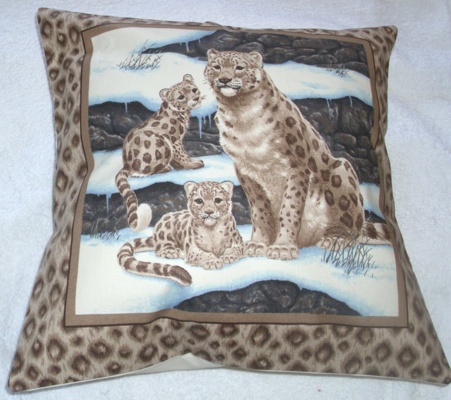 Beautiful Snow Leopard sitting with her two cubs cushion