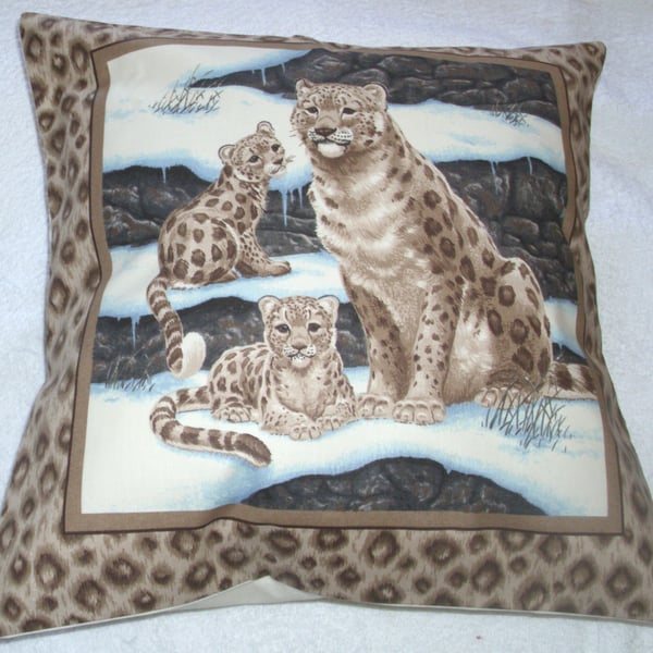 Beautiful Snow Leopard sitting with her two cubs cushion