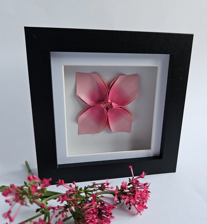 Pink origami flower in a shadow box frame
