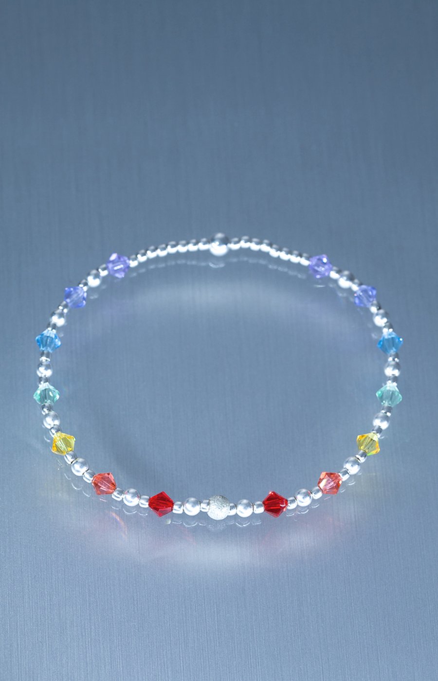 Sterling Silver bracelet with swarovski bicones in rainbow chakra colours