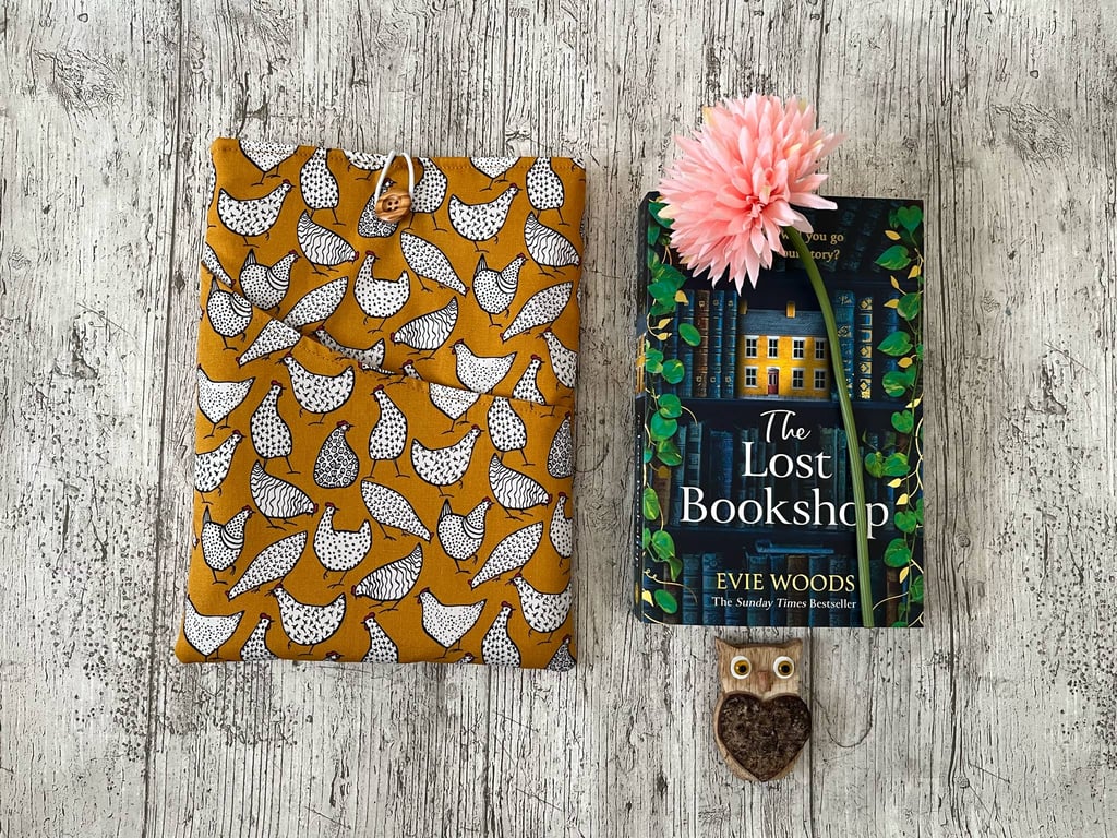 Fabric book sleeve with pocket for paperback book padded and fully lined. 