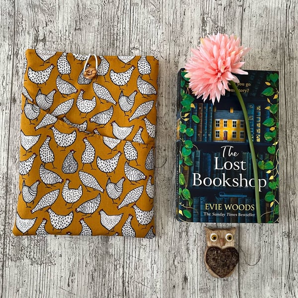 Fabric book sleeve with pocket for paperback book padded and fully lined. 