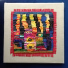 Mounted handwoven colourful tapestry weaving inspired by Hundertwasser